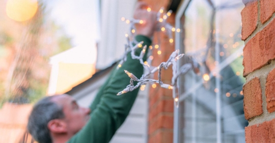 putting up holiday lights